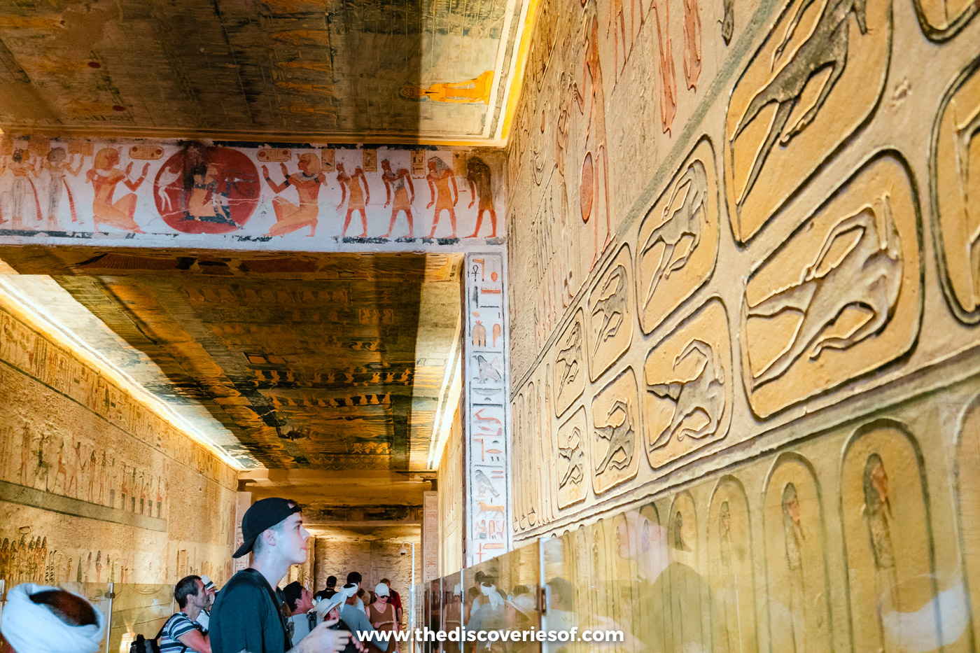Visitors in the wide first corridor of tomb KV6, its walls covered with the Litany of Ra, Luxor