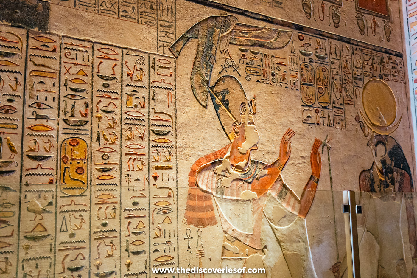 Painted relief of Ramses IX offering to the god Ra-Horakhty beside columns of hieroglyphs in tomb KV6