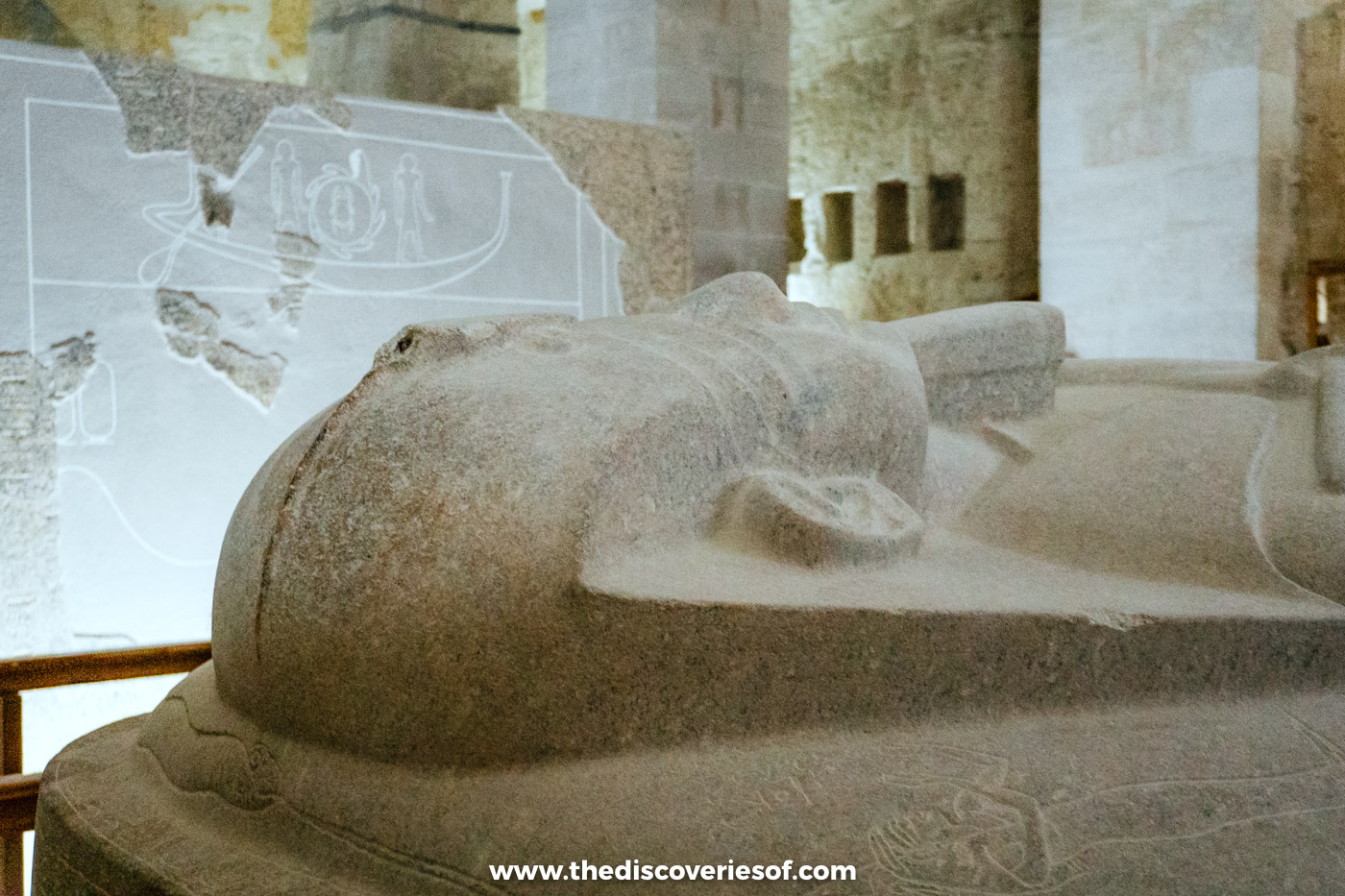 Head of Merenptah's granite effigy lid with the pillars of the burial chamber behind, tomb KV8, Luxor
