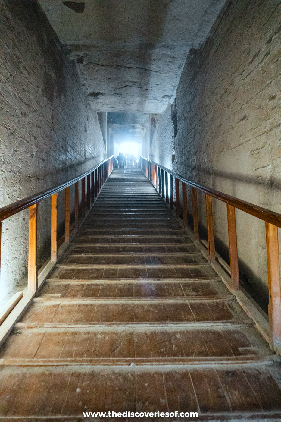 Steep wooden stairway rising towards daylight at the entrance of the tomb of Merenptah, Valley of the Kings