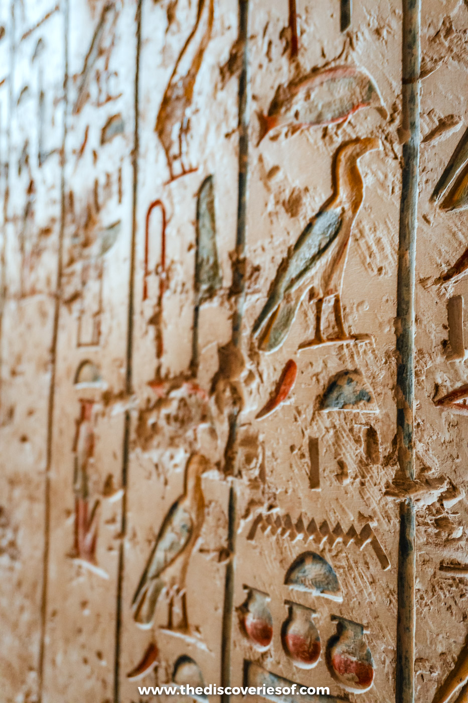 Carved hieroglyphs with traces of blue and red paint on the corridor wall of the tomb of Merenptah, KV8