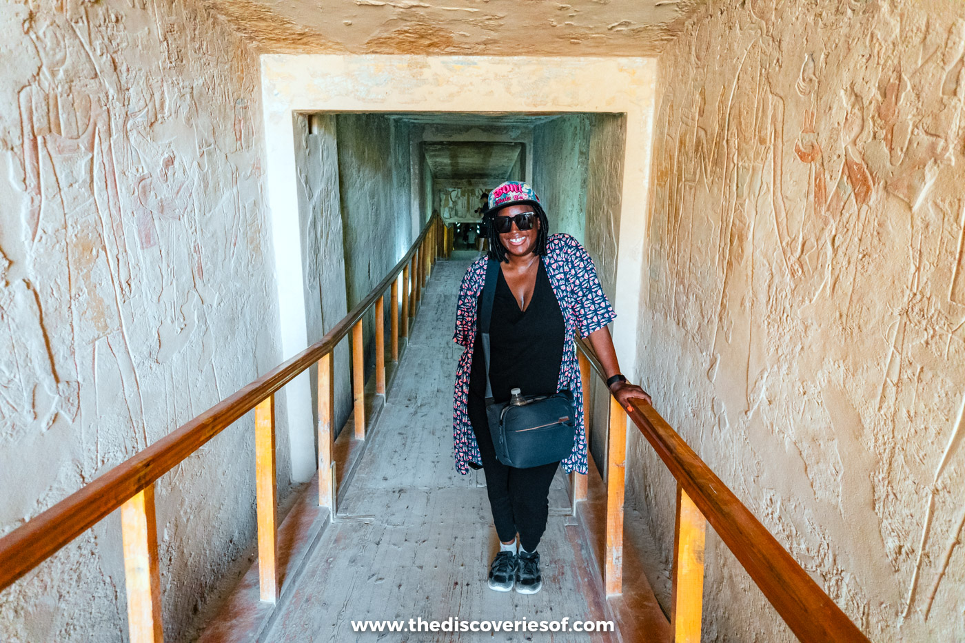 Julianna Barnaby standing on the wooden walkway in the decorated first corridor of tomb KV14, Luxor
