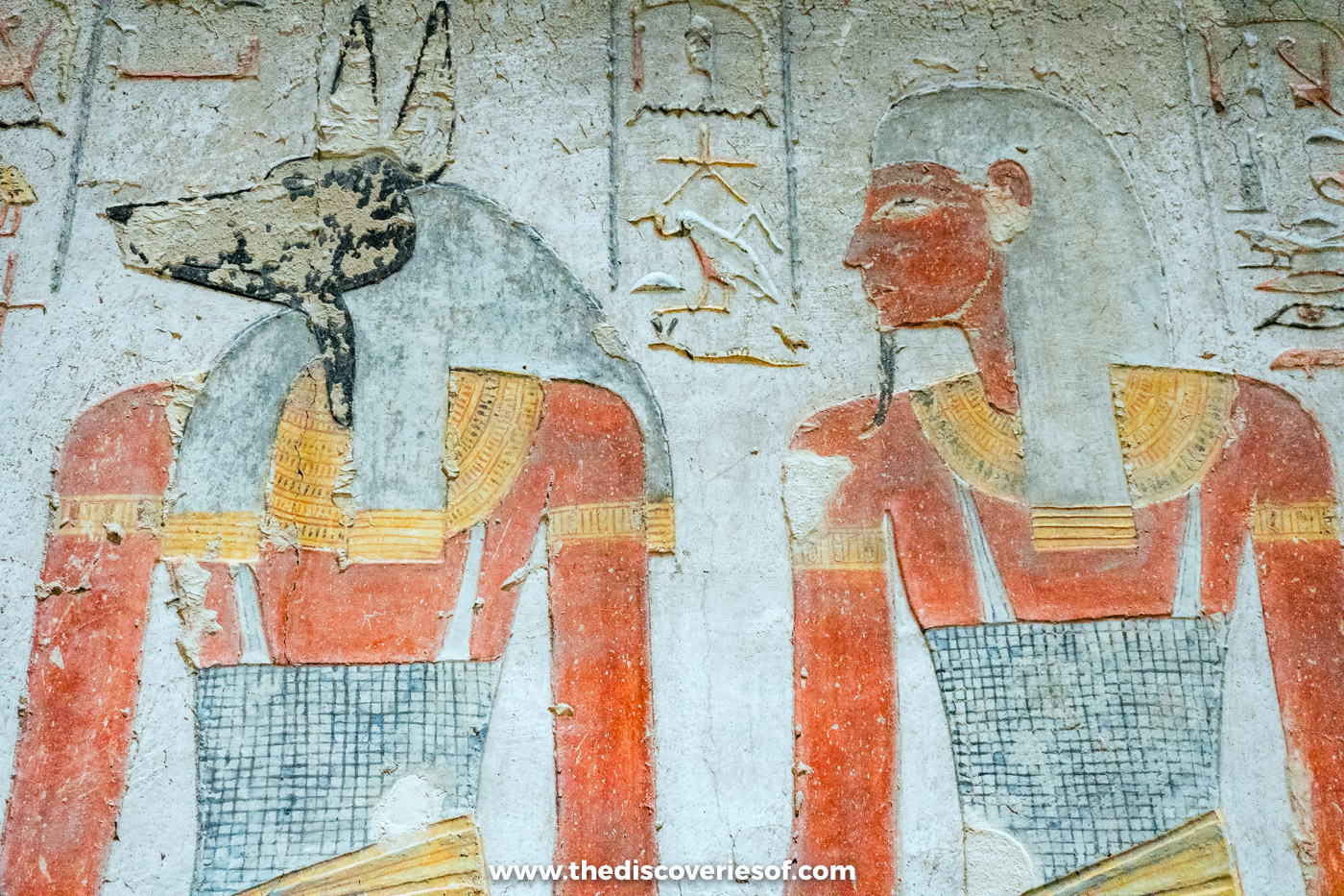 Painted relief of jackal-headed Anubis beside a royal figure in the first corridor of tomb KV14, Luxor