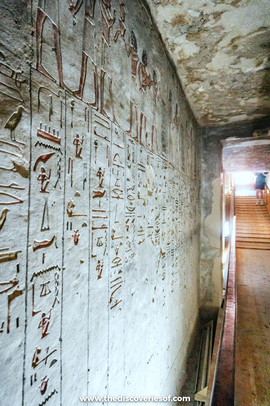 Columns of carved hieroglyphs lining a corridor wall with stairs beyond in tomb KV14, Valley of the Kings