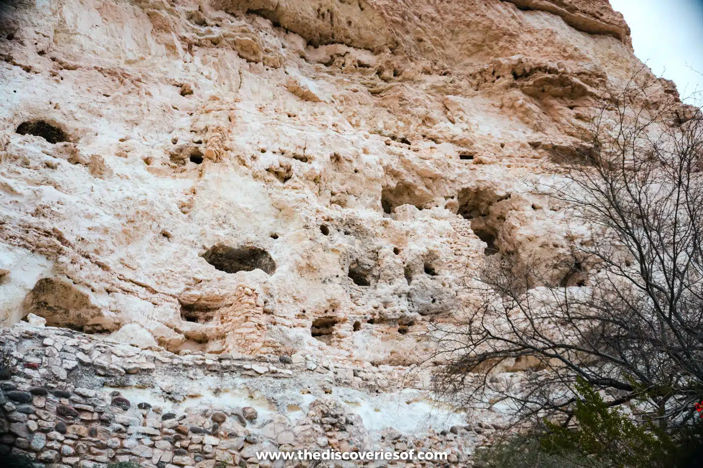 Pitted limestone cliff with remains of small stone dwellings in its hollows at Montezuma Castle, Arizona