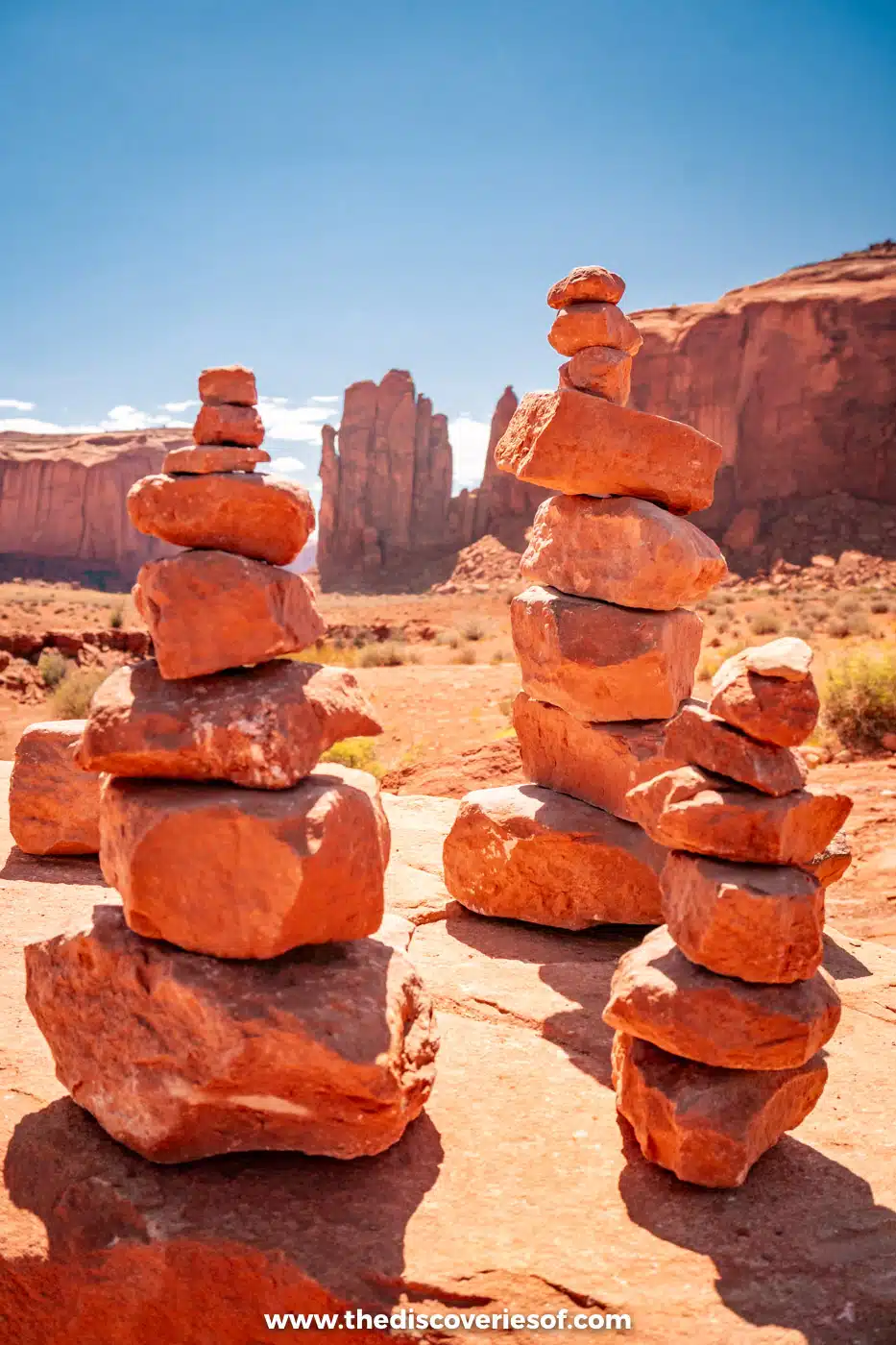 Stacks of red stones in front of sandstone buttes beside the Valley Drive in Monument Valley