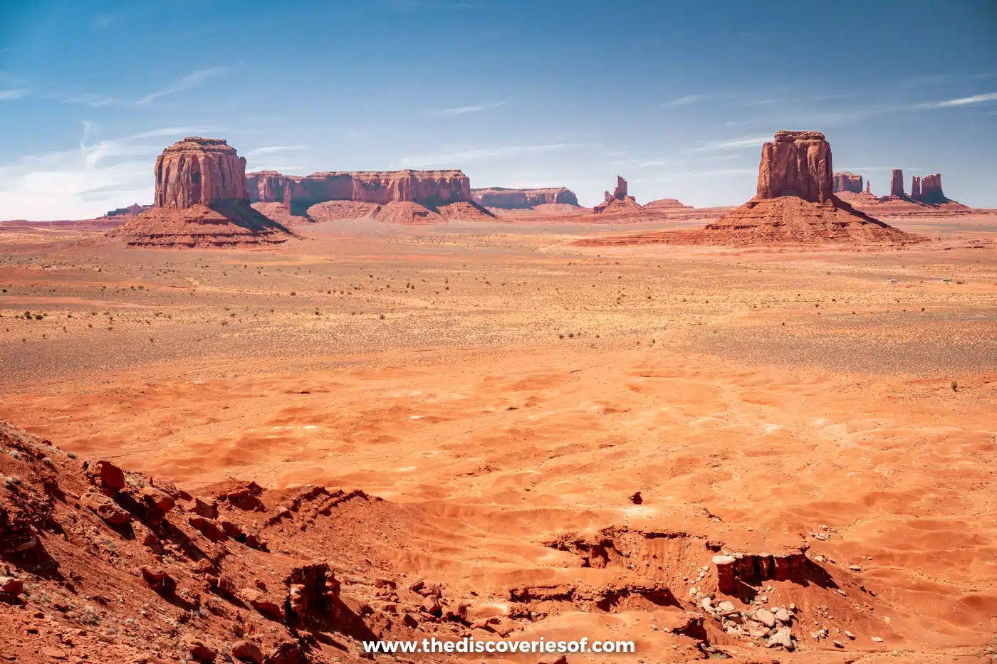 View over the red valley floor and distant buttes of Monument Valley