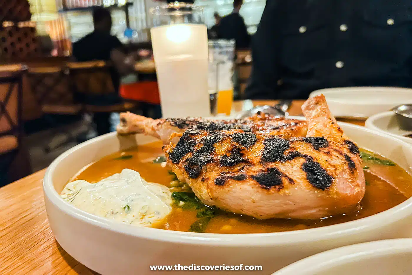 Smoked chicken in a bowl of sauce at Valentine restaurant, Phoenix