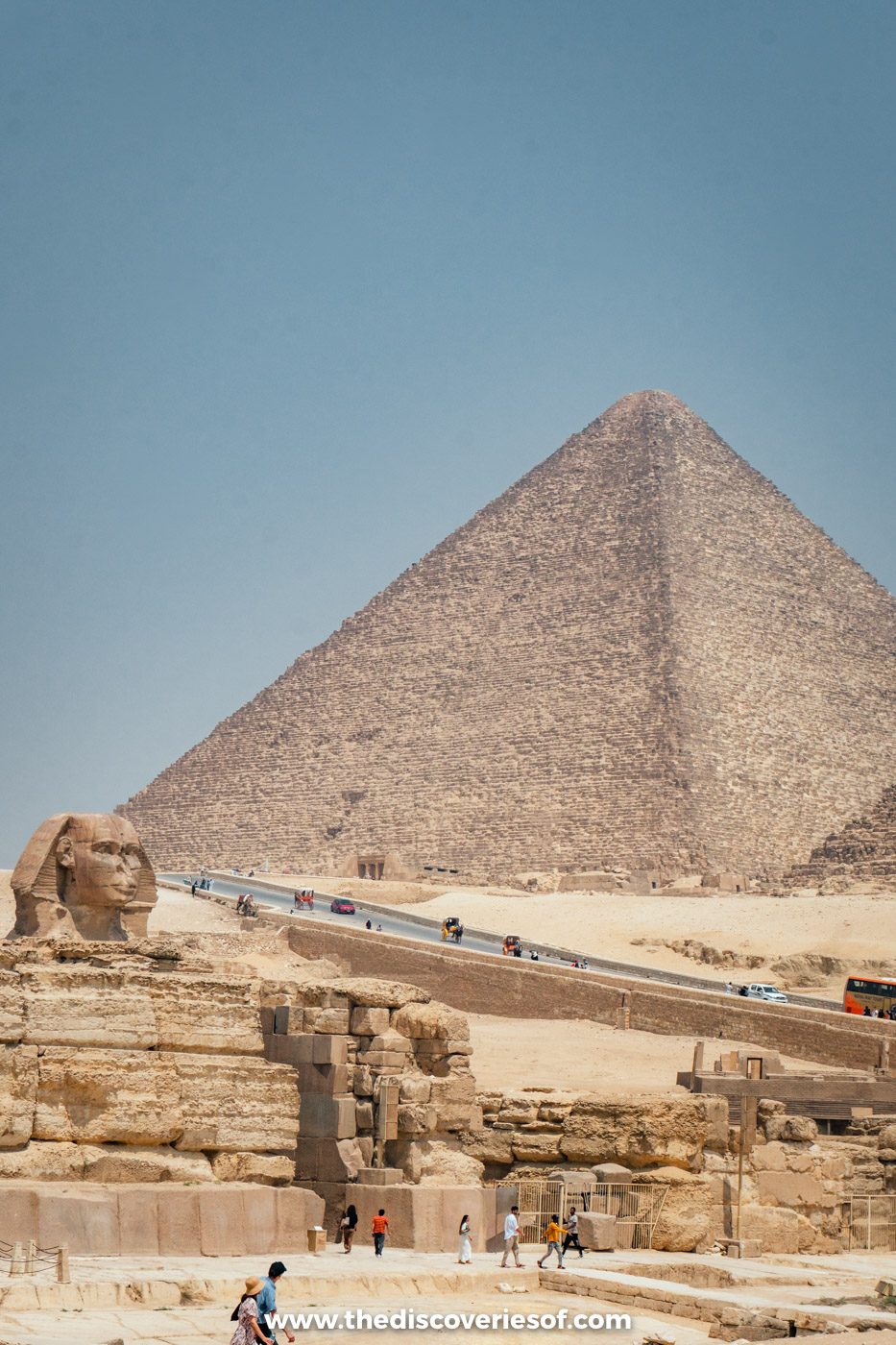 The Great Sphinx of Giza in its rock enclosure beside the Valley Temple, with the Great Pyramid rising behind
