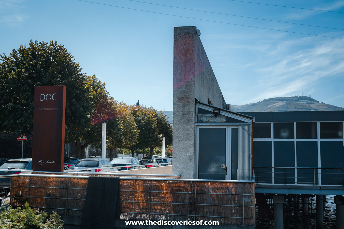 The rusted DOC sign and the modern concrete and glass building of DOC restaurant at Folgosa in the Douro Valley
