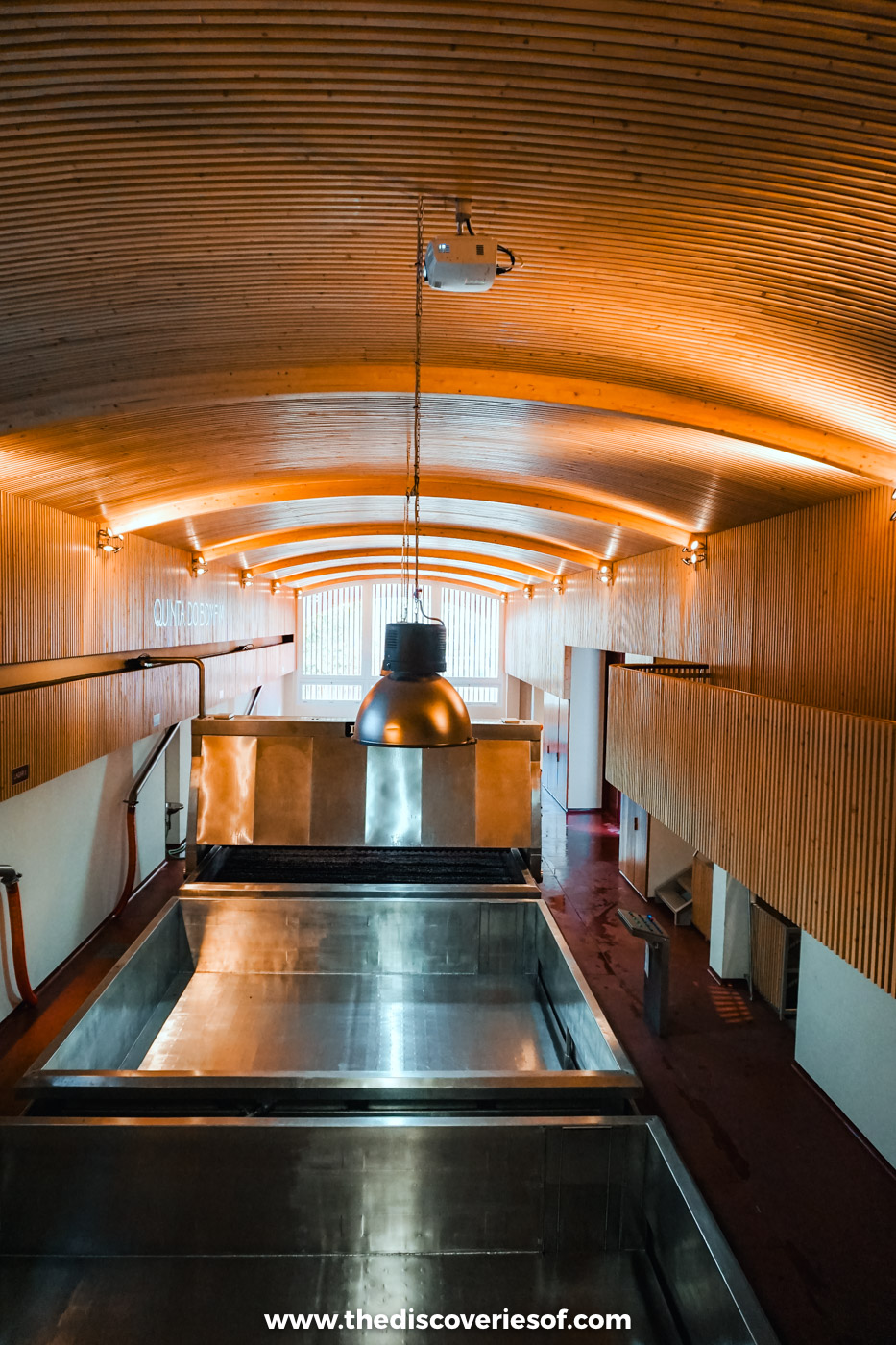 Shallow lagares for treading grapes under a curved wooden ceiling in the winery at Quinta do Bomfim, Pinhão