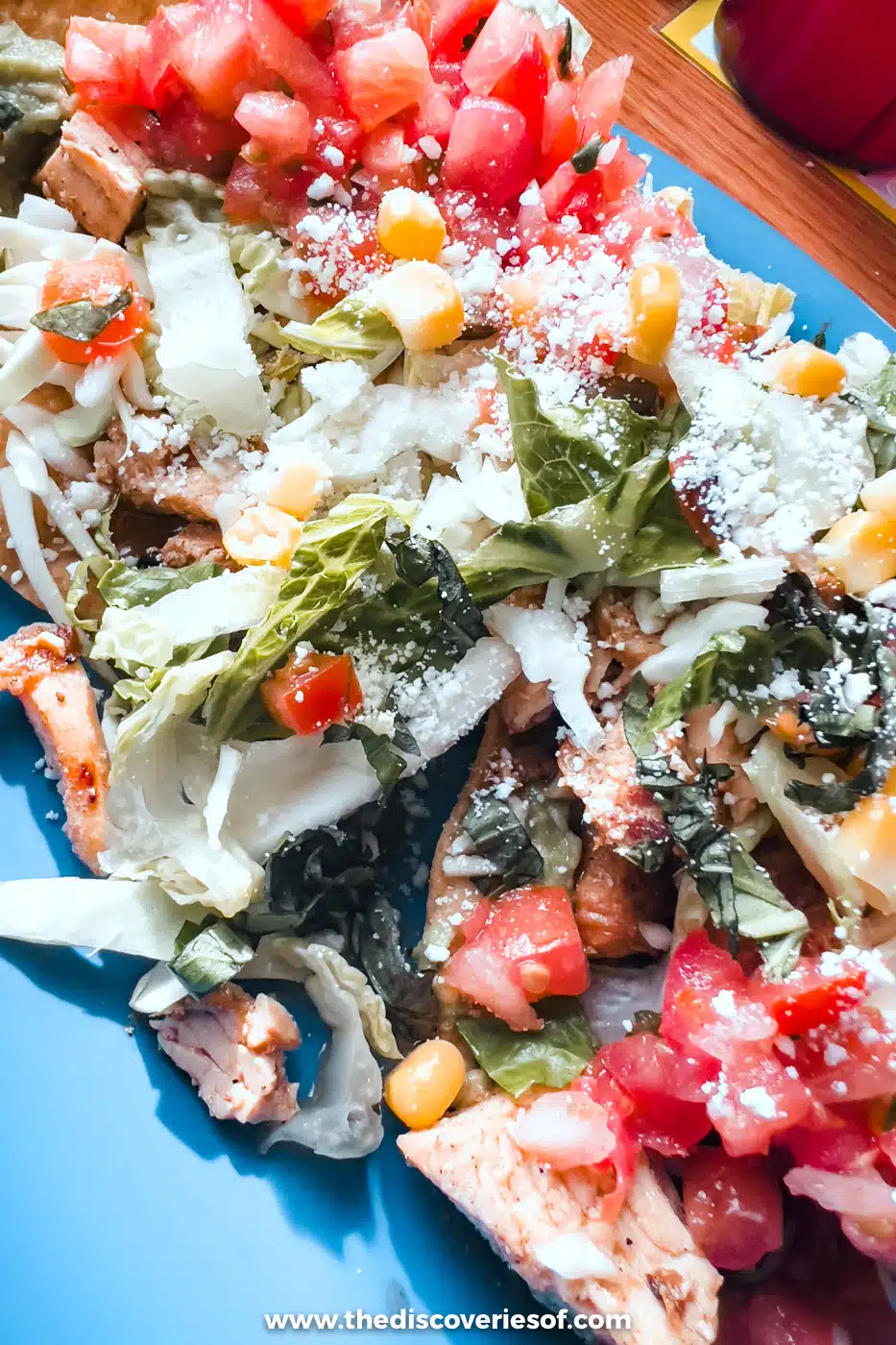 A chicken tostada piled with tomato, cabbage, cheese and corn at Bumble Bee's Baja Grill, Santa Fe