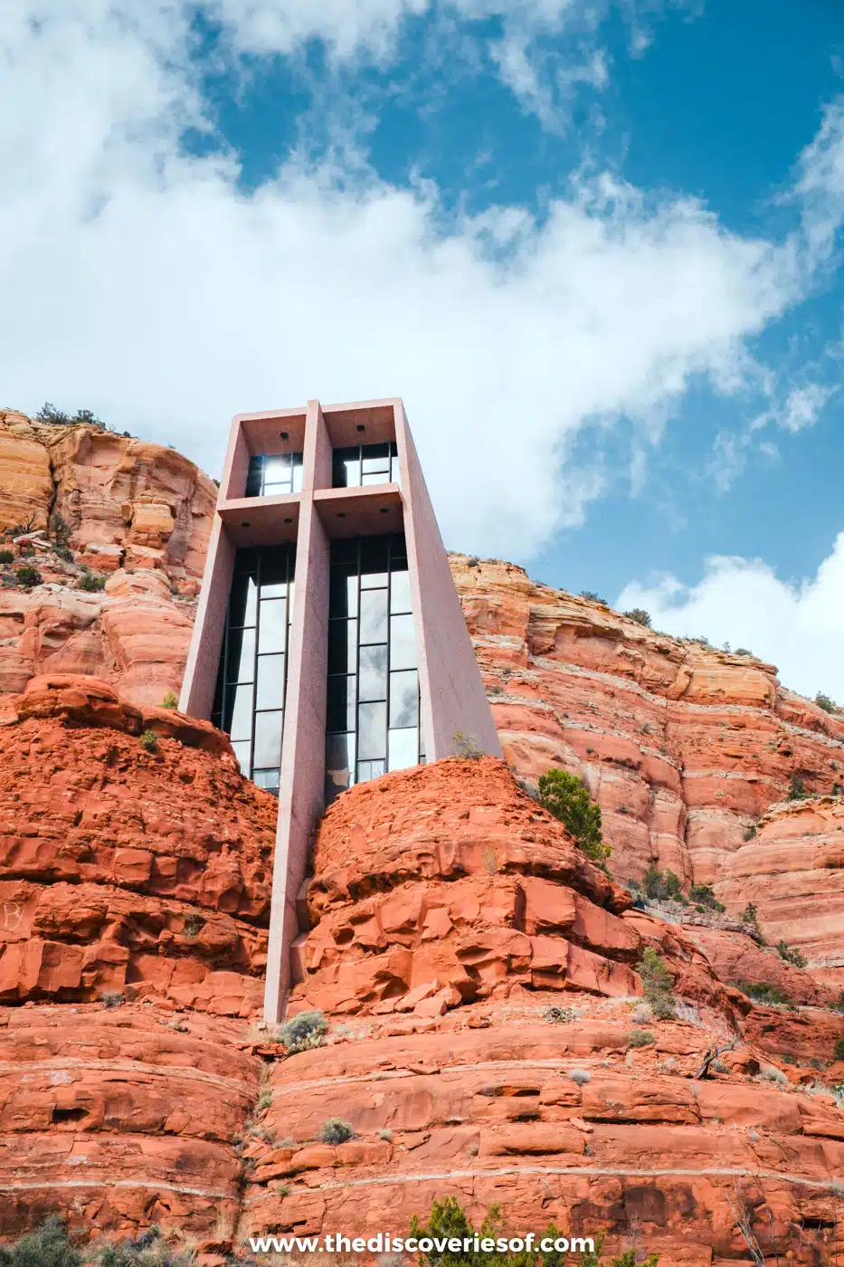 The Chapel of the Holy Cross and its tall cross built into red rock buttes in Sedona