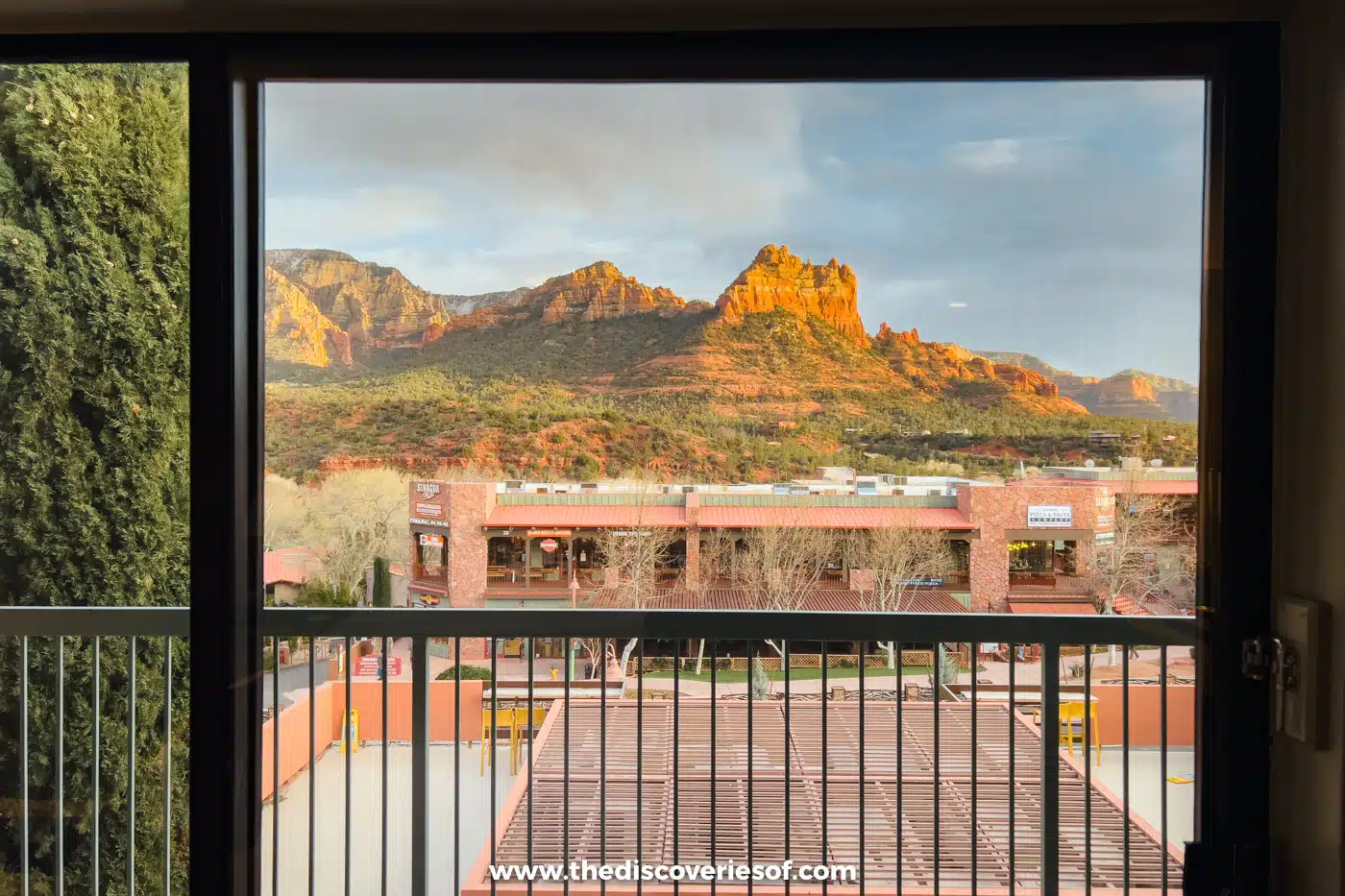 Red rock cliffs above Uptown Sedona seen through a hotel room door at the Matterhorn Inn