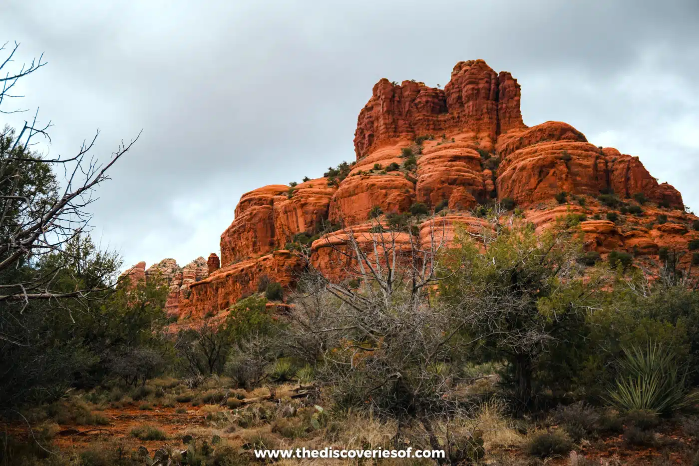 The red sandstone layers of Bell Rock under a cloudy sky in Sedona