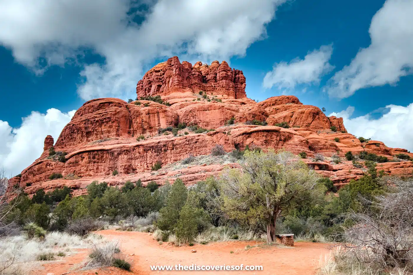 Bell Rock rising above juniper scrub under a blue sky near Sedona, Arizona