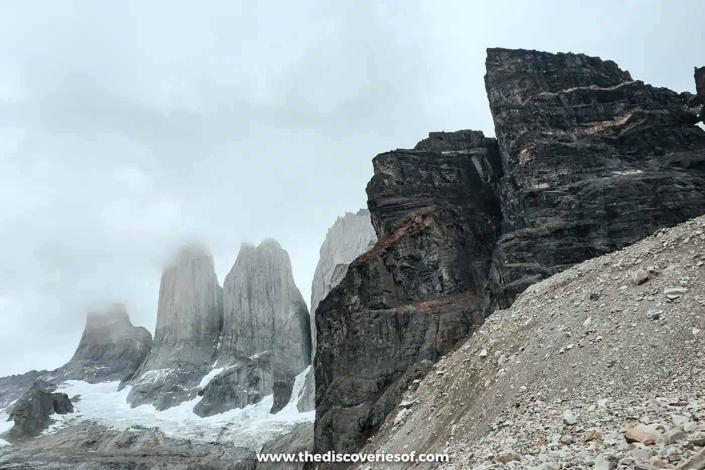 The three granite towers of Torres del Paine in cloud above their glacier, Chile