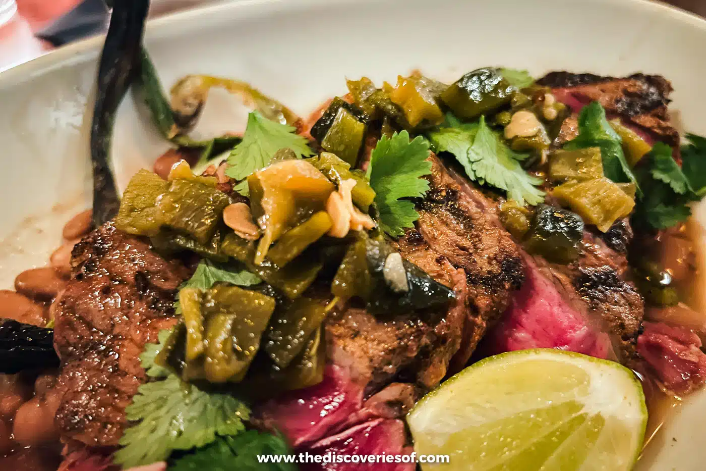 Grilled steak topped with green chiles, coriander and a lime wedge at Tito & Pep, Tucson