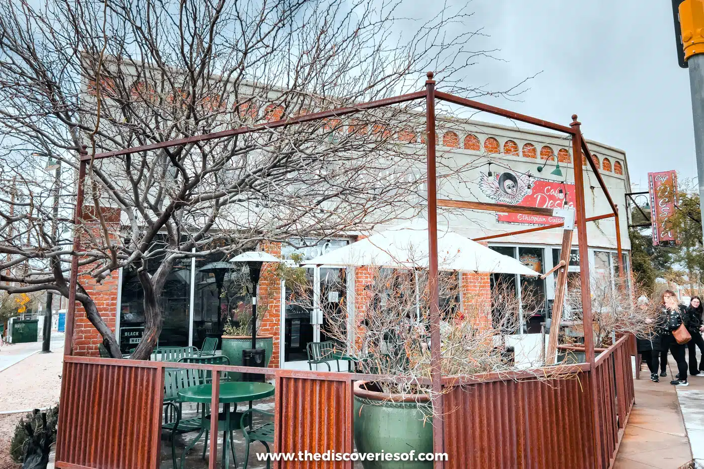 A shady patio with tables and bare trees outside a historic building in Barrio Viejo, Tucson
