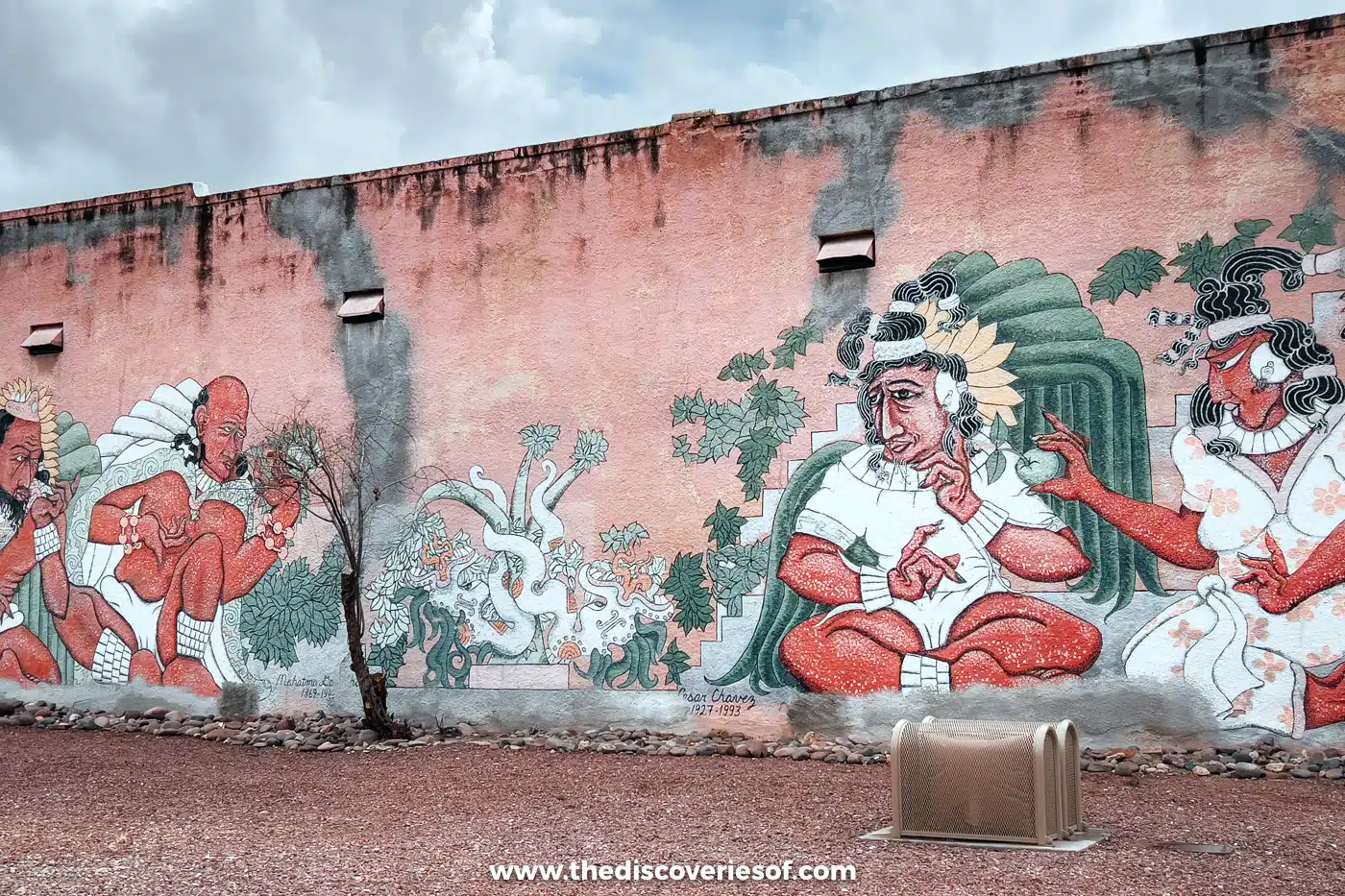 A colourful mural of Indigenous figures painted on an old adobe wall in Barrio Viejo, Tucson