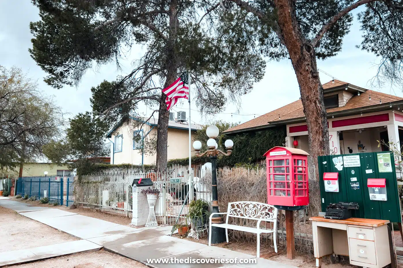 A quiet street of low adobe houses with a red phone box in Barrio Viejo, Tucson