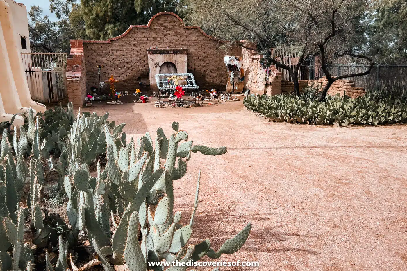 Candles, flowers and offerings at the crumbling adobe El Tiradito wishing shrine in Tucson