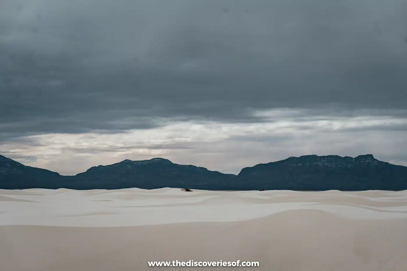 Rolling white gypsum dunes under a cloudy sky at White Sands National Park, New Mexico